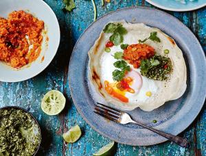 a blue plate of food with a egg and salsa at The Palms Inn I Near Medanta Medicity I Sec-38 in Gurgaon
