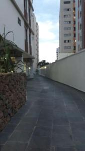 an empty sidewalk in a city with tall buildings at Edificio Namberuã in Guarujá