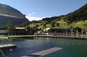 a large pool of water in front of a building at Chalet Adlerhorst am Großglockner in Heiligenblut +37 photos