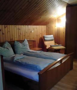 a bedroom with a bed and a chair in it at Chalet Adlerhorst am Großglockner in Heiligenblut