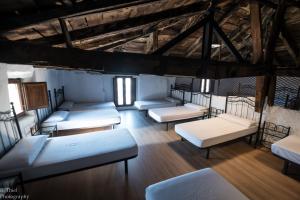 a room with a bunch of beds in it at Albergue Rosalia / Pilgrim Hostel in Castrojeriz