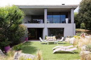 a house with a table and chairs in the yard at Villa Mare Monti in Lumio