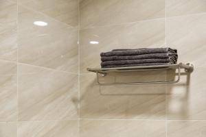 a stack of towels on a towel rack in a bathroom at soul stay in Busan +37 photos