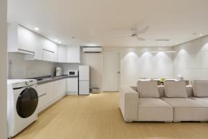a kitchen and living room with a couch and a table at soul stay in Busan
