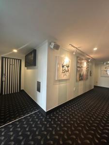a large room with white walls and paintings on the wall at Hotel Le'O in Seoul