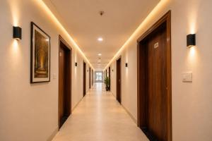 a corridor of a hallway with a long hallway at Hotel Sugandh Retreat Near Bus Stand Jaipur in Jaipur +57 photos
