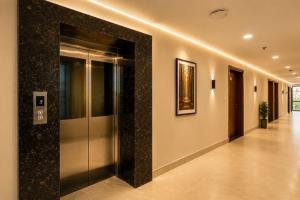a hallway with a elevator in a building at Hotel Sugandh Retreat Near Bus Stand Jaipur in Jaipur