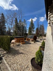 a patio with couches and chairs in a yard at Apartamenty u Załogi in Zakopane
