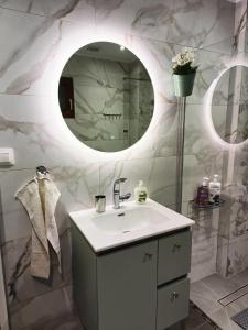 a bathroom with a sink and a mirror at Polys Apartment and Paraskevi studio with view in Ptolemaida +127 photos