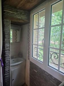 a bathroom with a sink and a window at Le Moulin de Bréhaut in Augan