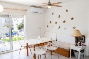 a dining room with a table and chairs and stars on the wall at Marilia GuestHouse - Seaside Retreat in Evia in Agia Anna