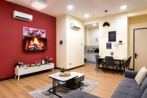 a living room with a couch and a fireplace at VH HOMES l Imago Mall l 2BR Family Suite l Garden Direct Access in Kota Kinabalu