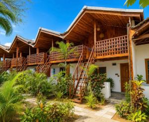 a house with wooden stairs in front of it at Beach Wave Hotel in Arugam Bay