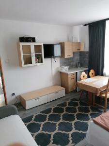 a small kitchen with a table and a dining room at Bowal in Grzybowo