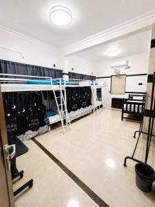 a room with several racks of clothes on display at W H Nest Hostel in Cochin +16 photos