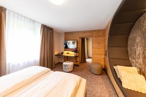a hotel room with a bed and a desk at Hotel Waldmühle in Zella-Mehlis