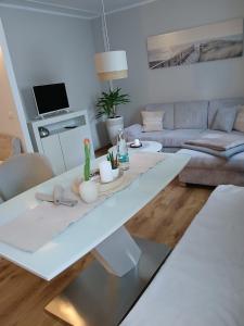 a living room with a white table and a couch at Wohlfühloase mit Sauna in Mayen