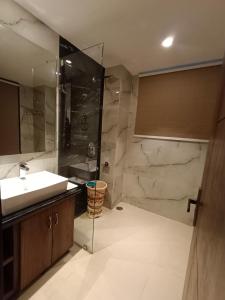 a bathroom with a sink and a shower at RR Hotel & Resort by Sonachi in Dharamshala +19 photos