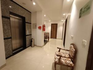 a hallway with a chair in a building at RR Hotel & Resort by Sonachi in Dharamshala