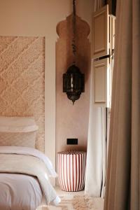 a bedroom with a bed and a chandelier at Maison Zamane in Marrakesh +59 photos