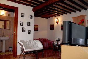 a living room with a tv and a couch at Casa Vacanze in Borgo in Monteverdi Marittimo