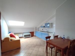 a living room with a couch and a table at Residence Hotel Azzurro in LʼAquila