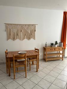 a dining room with a wooden table and chairs at Le Néococoon in Neufchâteau