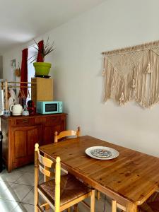 a dining room table with two chairs and a plate on it at Le Néococoon in Neufchâteau +4 photos