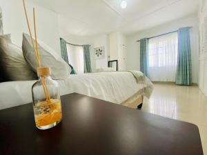 a room with a table with a bottle on top of it at Meyrick Bed and Breakfast in Harare