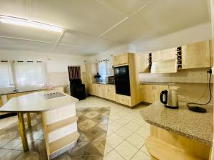 a kitchen with wooden cabinets and a counter top at Meyrick Bed and Breakfast in Harare