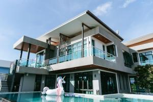 a house with a pool and a unicorn in front of it at Sky Beach Pool Villa Chanthaburi 1 in Laem Sing