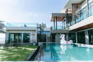 a house with a pool with a unicorn in the water at Sky Beach Pool Villa Chanthaburi 1 in Laem Sing
