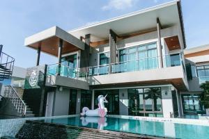 a house with a pool and a pink unicorn in front of it at Sky Beach Pool Villa Chanthaburi 1 in Laem Sing +44 photos
