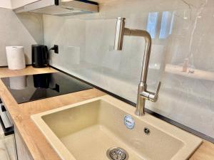 a kitchen sink with a faucet on a counter at Azur Mare Luxury Villas in Neoi Epivates +106 photos