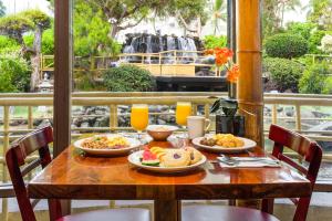 a wooden table with plates of food on it at Pagoda Hotel in Honolulu