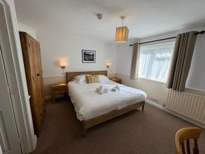 a bedroom with a bed with two stuffed animals on it at Byways Serviced Apartments in Salisbury