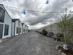 a row of houses sitting on a dirt road at Naryn Barnhouses in Naryn