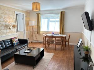 a living room with a couch and a table at Byways Serviced Apartments in Salisbury