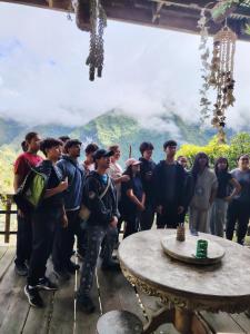 a group of people standing in front of a table at Ramon's Homestay in Banga-an +5 photos
