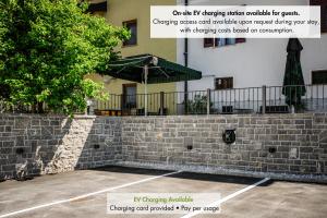 a brick retaining wall in front of a building at Apartmaji Tinta in Kanal +29 photos