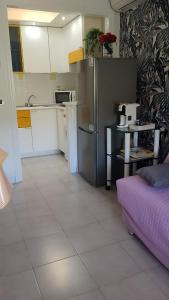 a kitchen with a stainless steel refrigerator in a room at Bilocale sul Trasimeno in San Feliciano