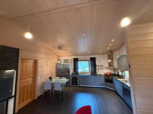 a large kitchen with a table in the middle at Villa Polly, Jaala, Luxury cottage with private sauna in Kouvola