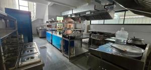 a large kitchen with many appliances in a kitchen at ANTARA STAY in Coimbatore
