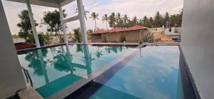 a reflection of a house in a swimming pool at ANTARA STAY in Coimbatore
