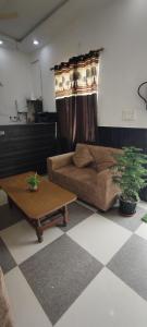a living room with a couch and a coffee table at La Buddha Villagers Homestay - Near Taj Mahal Agra in Agra
