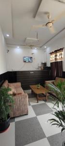a living room with a couch and a table at La Buddha Villagers Homestay - Near Taj Mahal Agra in Agra