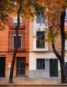 a building with two trees in front of it at Iberos Home in Seville