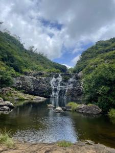 a waterfall in the middle of a river at Jay&Kay CosyRoom FlicEnFlac in Flic-en-Flac