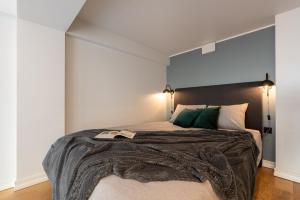 a bedroom with a large bed with two lights at Old Town Loft in Tartu