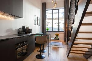 a kitchen with a counter and a table with a chair at Old Town Loft in Tartu